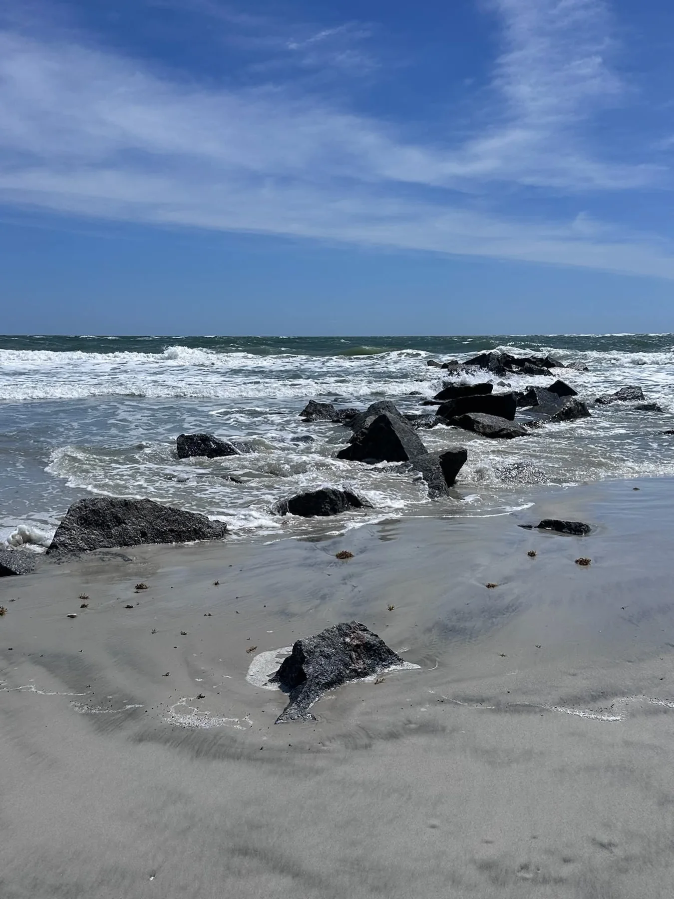 Waves washing over rocks on the beach